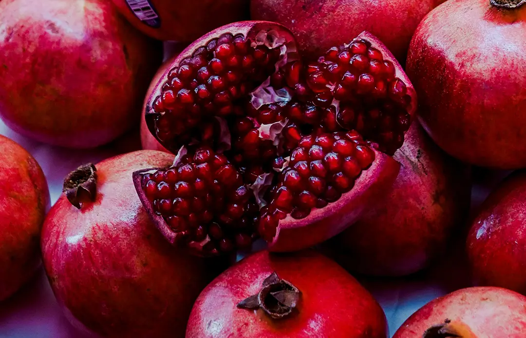 Fresh pomegranates with one cut open