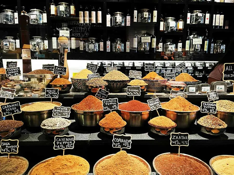 Assorted spices on display in a market.