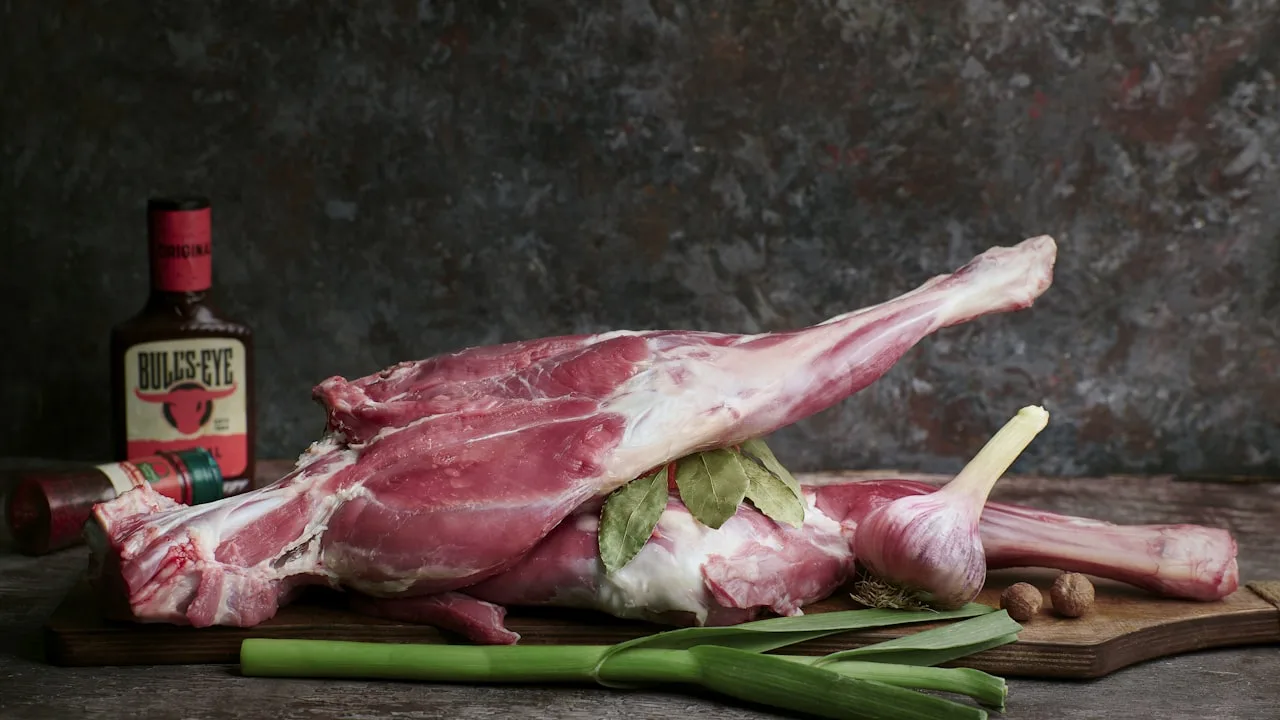 Raw lamb leg with cooking ingredients.