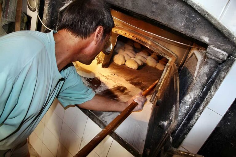 Baker using a traditional oven