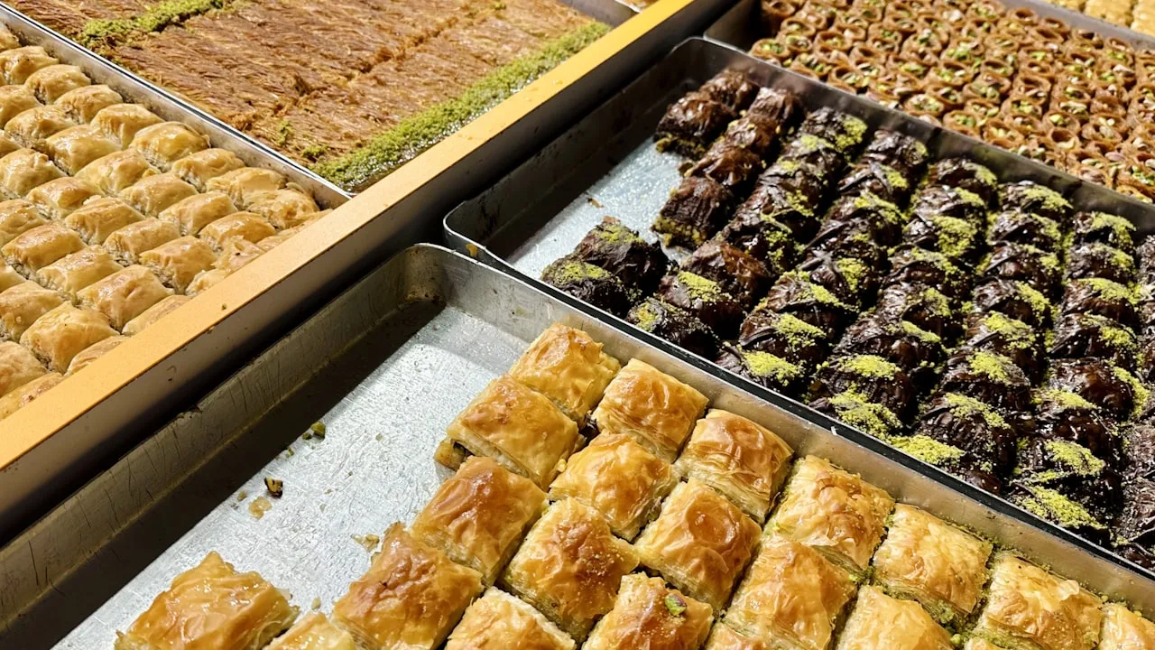 Assorted baklava and pistachio pastries in trays