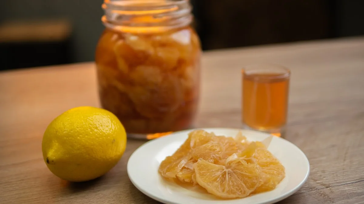 Lemon, jar, plate, and glass on table