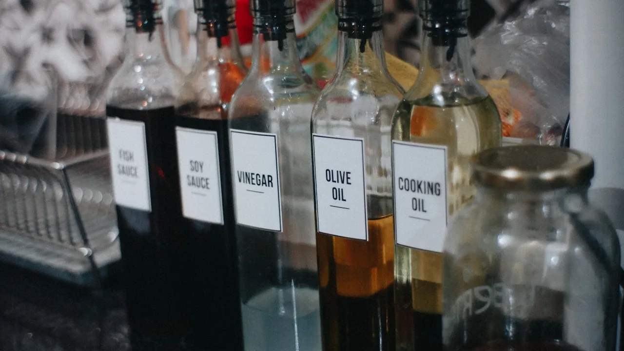 Labelled condiment bottles on a kitchen counter